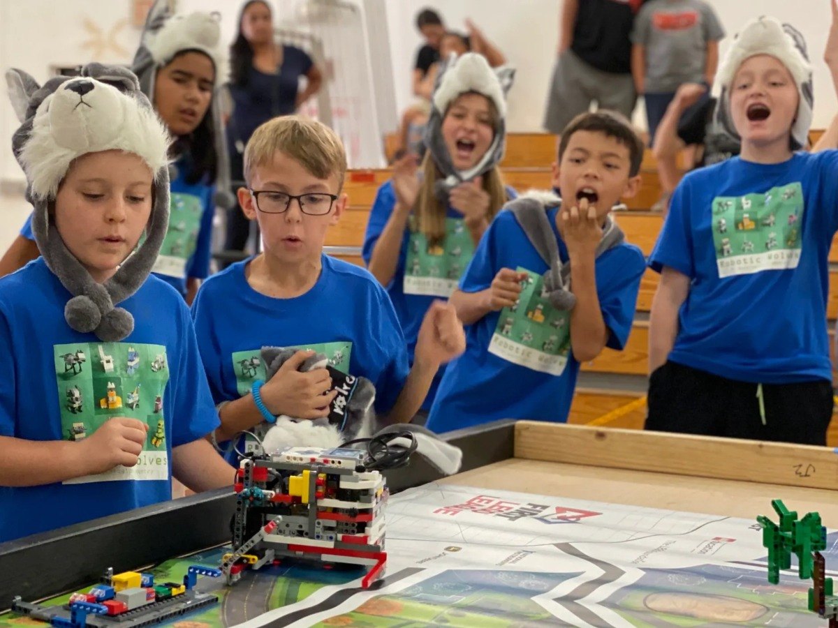 Code N Bots students cheering at a robotics competition
