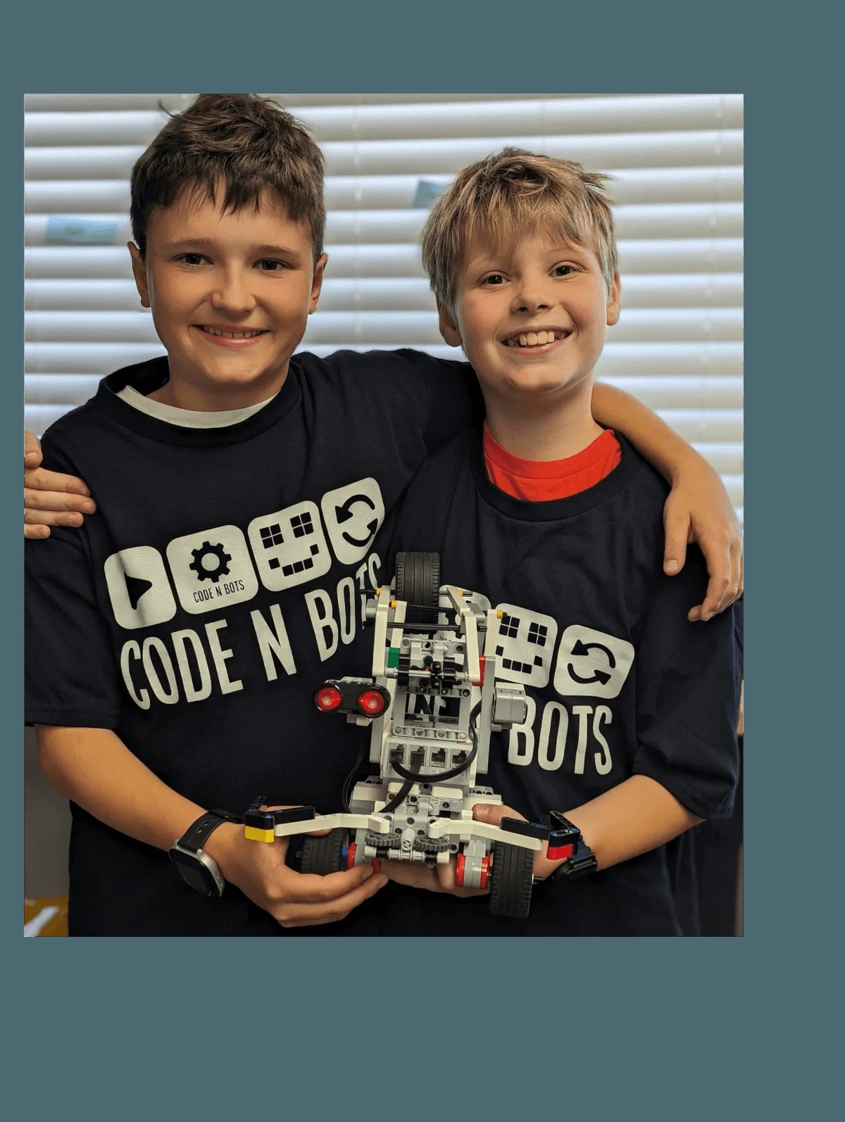 Code N Bots students with a robot they built